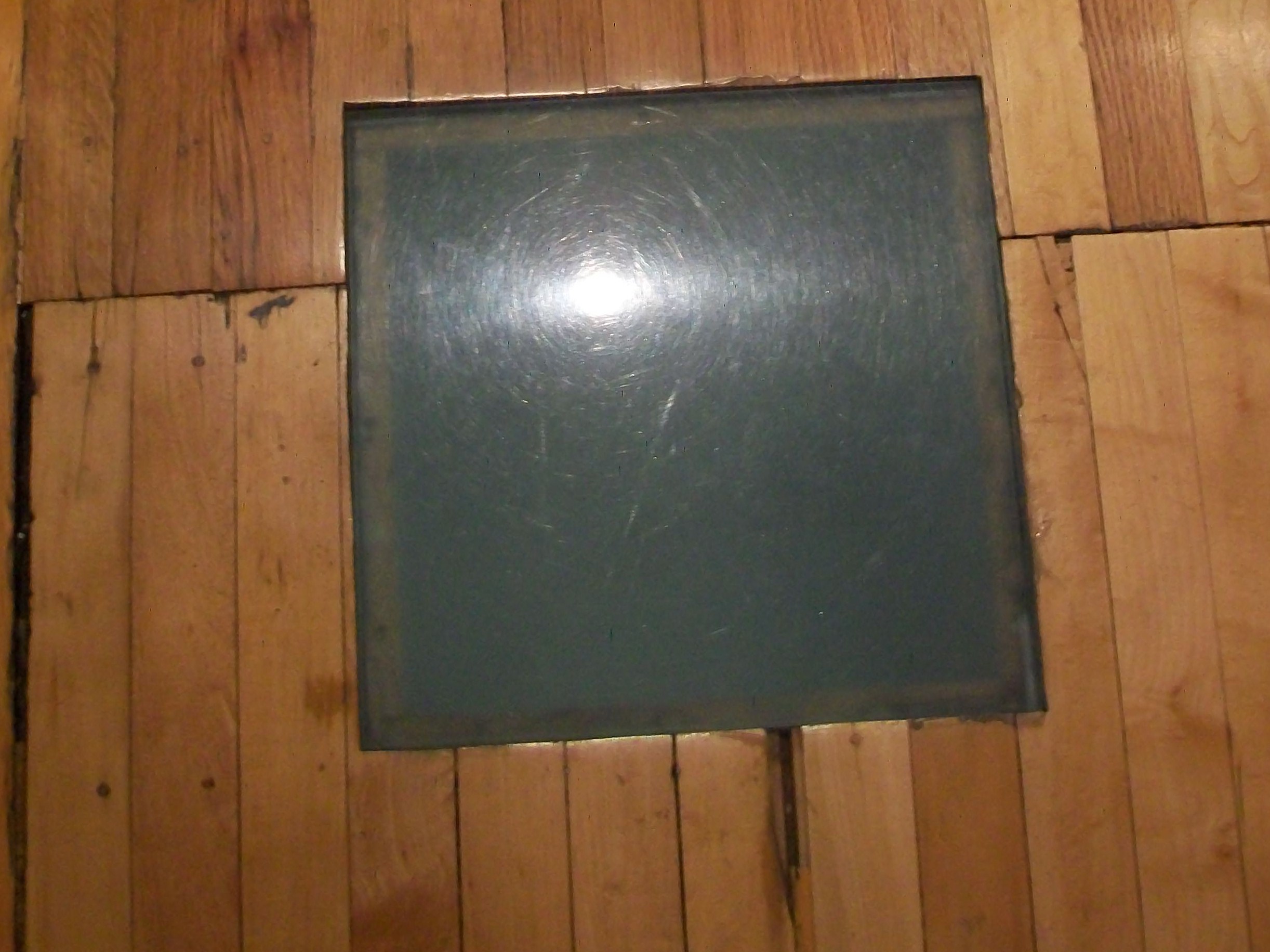 Several squares on main floor allow muted light up from the basement when lights are on.